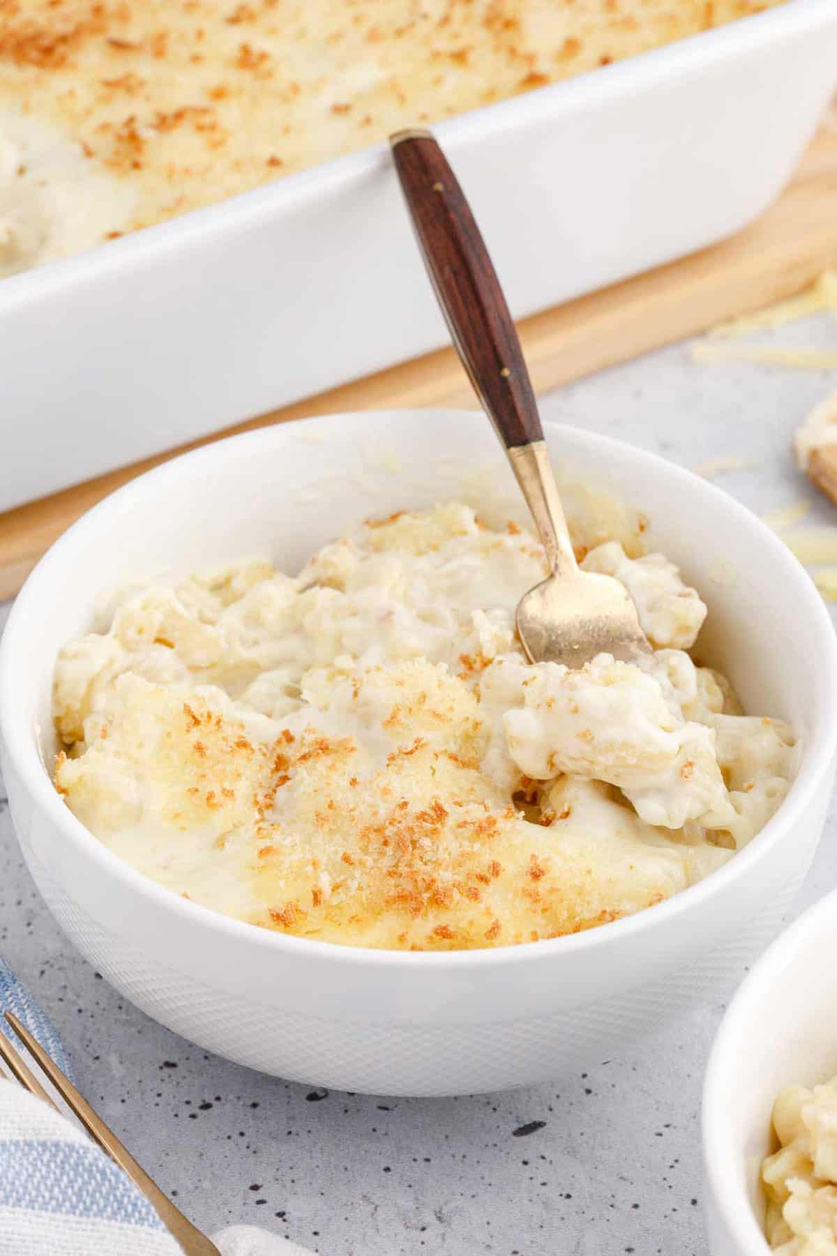 Baked White Cheddar Mac and Cheese in a Bowl With a Spoon