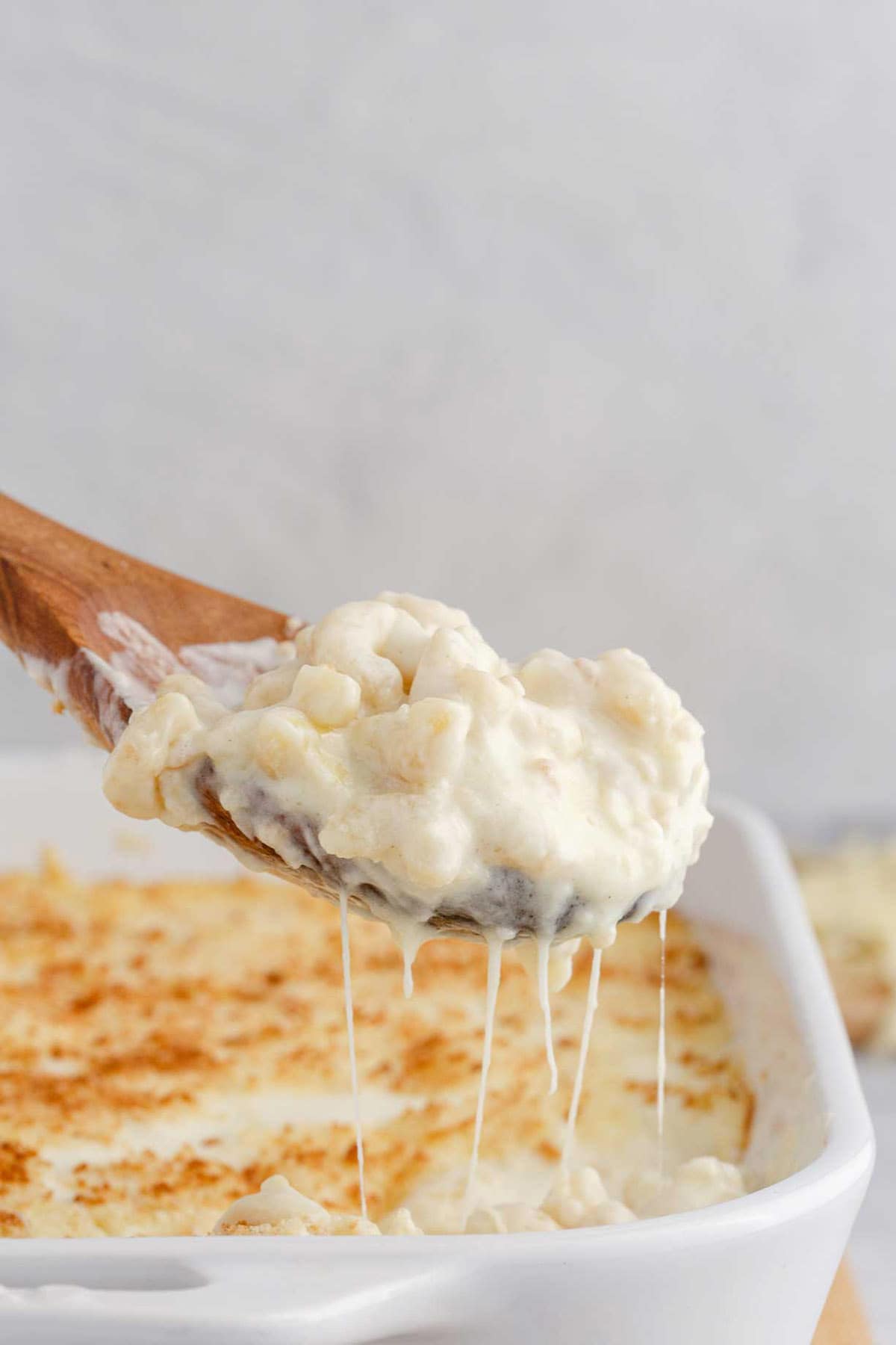 Baked White Cheddar Mac and Cheese Being Spooned Out