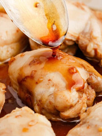 Chicken Thighs with Honey Sauce Being Spooned Over