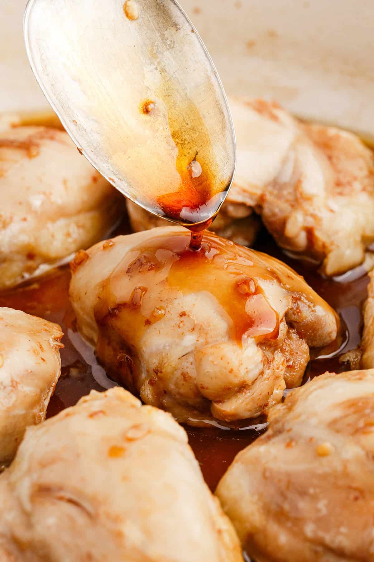 Chicken Thighs with Honey Sauce Being Spooned Over