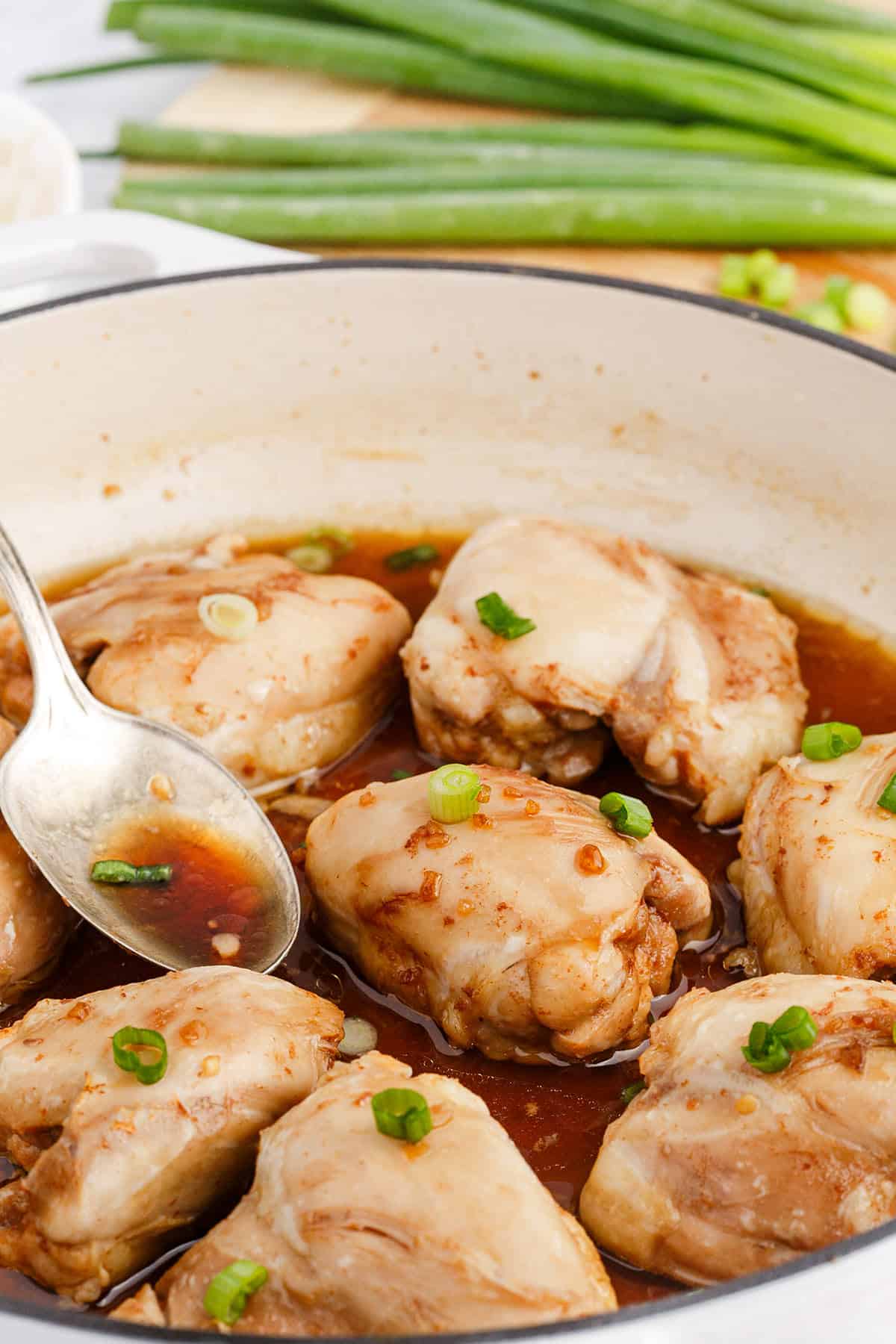 Chicken Thighs with Honey in a Pan Garnished with Green Onions