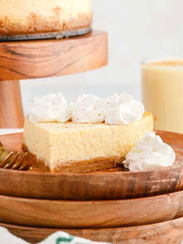 Eggnog Cheesecake Slice With Whipped Cream and Fork