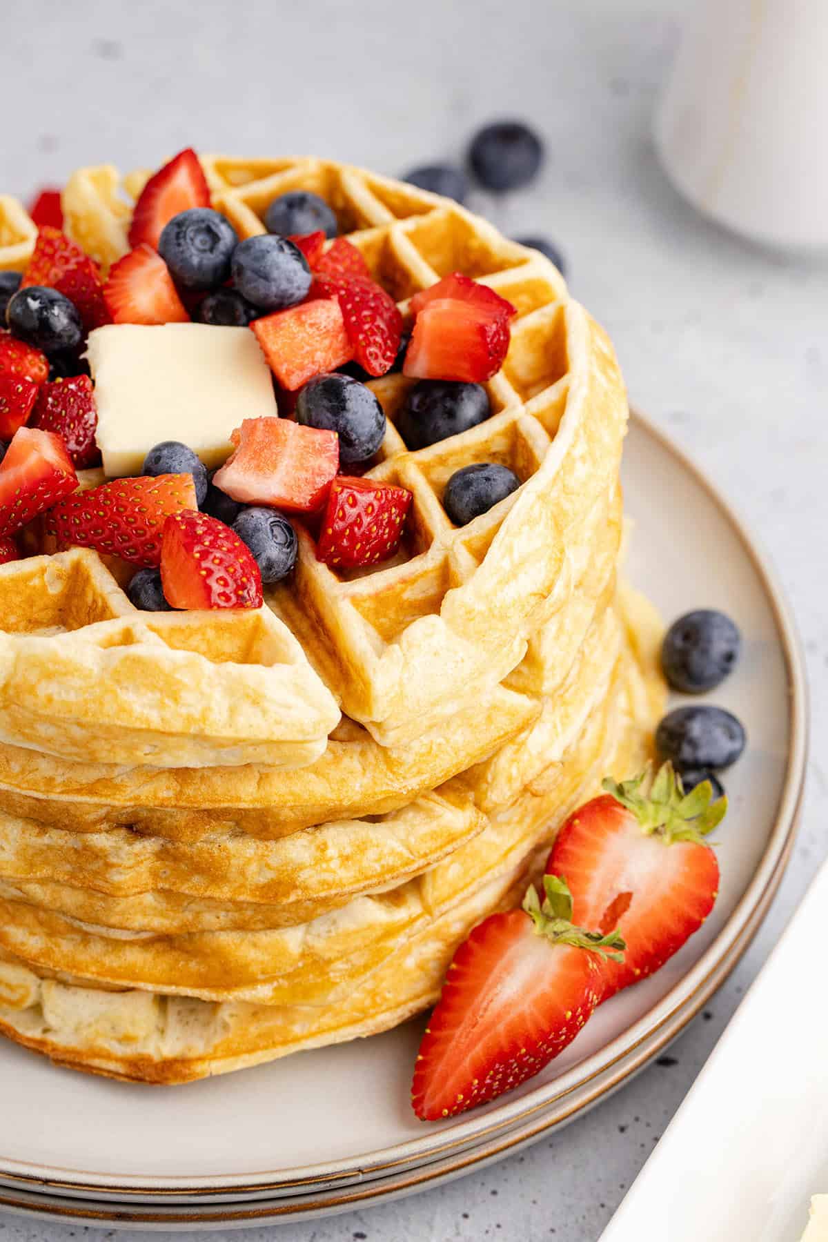 Gluten Free Buttermilk Waffles Stacked on a Plate with Berries