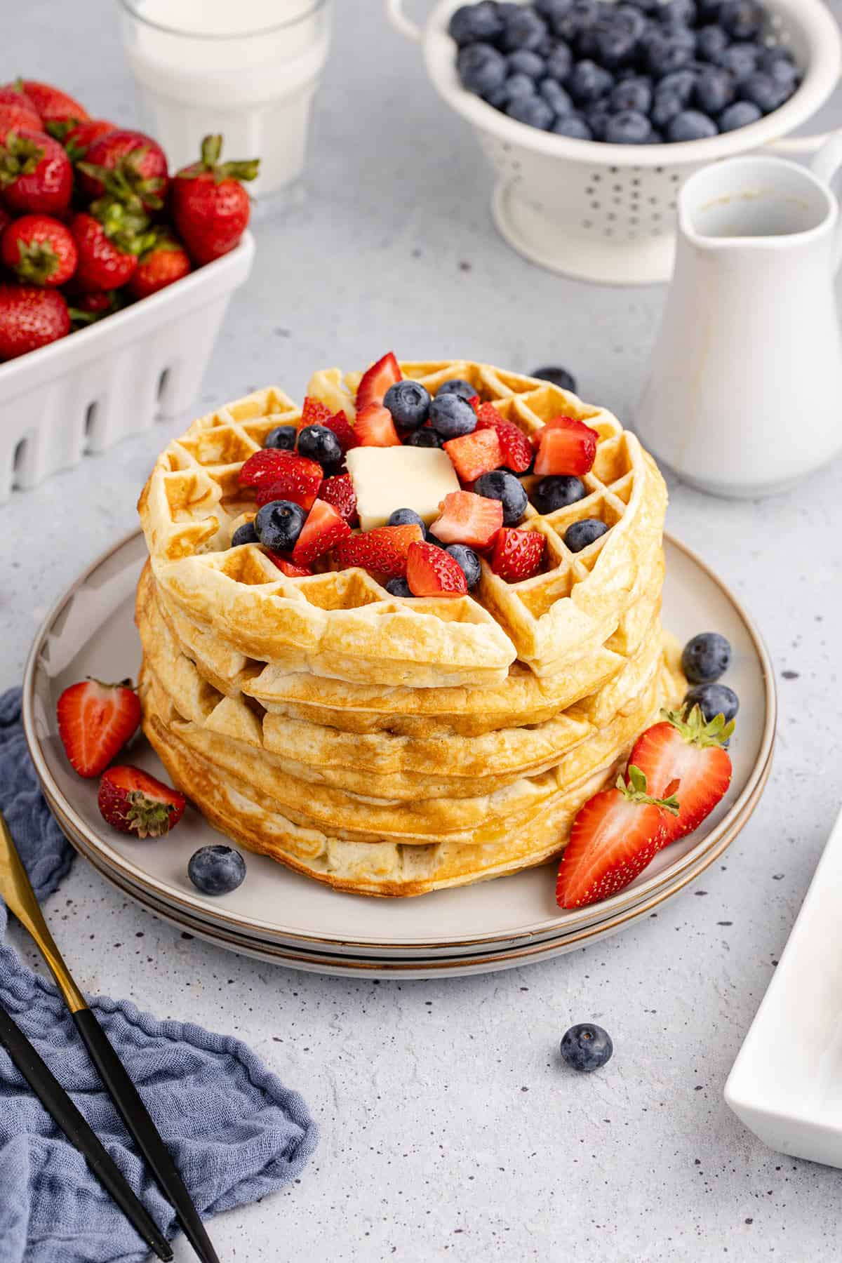 Gluten Free Buttermilk Waffles Stacked on a Plate with Berries