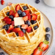 Gluten Free Buttermilk Waffles Stacked on a Plate with Berries