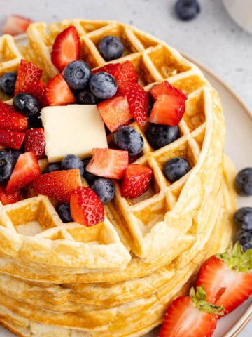 Gluten Free Buttermilk Waffles Stacked on a Plate with Berries