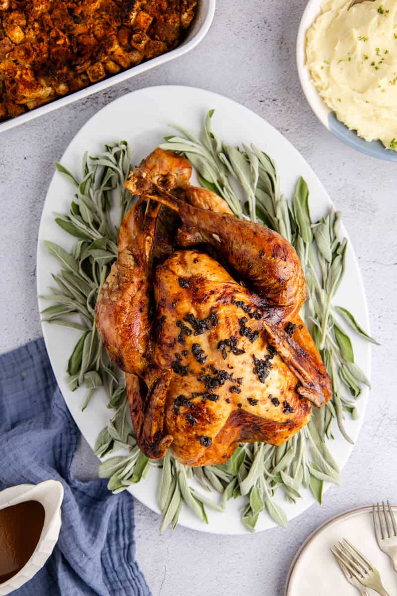 Herb Butter Turkey Cooked On a Platter with Fresh Sage