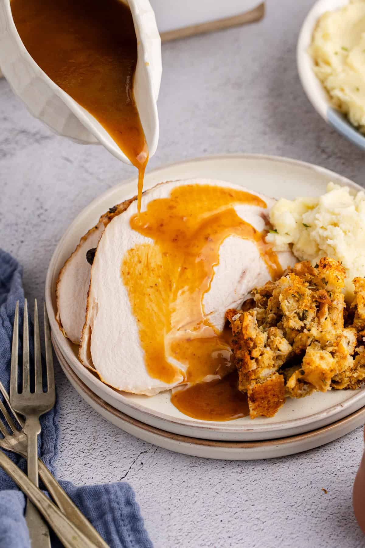 Herb Butter Turkey Sliced With Gravy On Top Being Poured