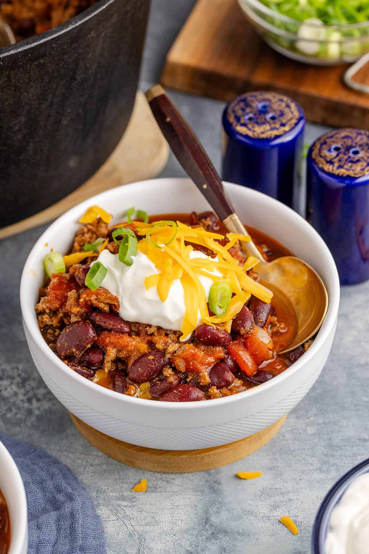 Stove Top Chili in a Bowl Garnished with Sour Cream, Cheese and Green Onion