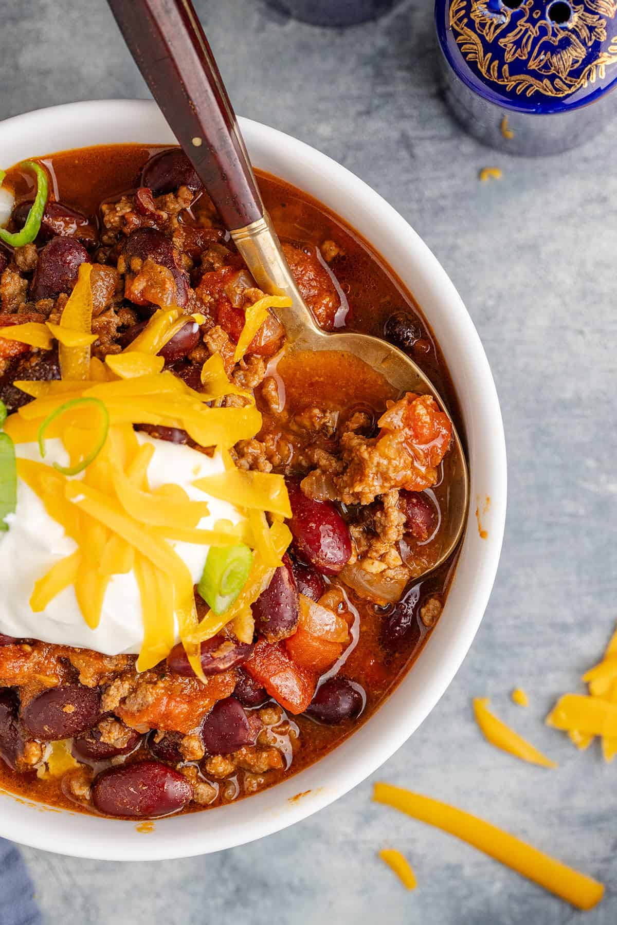 Stove Top Chili in a Bowl Garnished with Sour Cream, Cheese and Green Onion