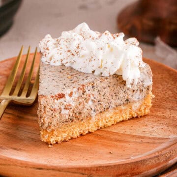 Tiramisu Cheesecake On a Plate With Whipped Cream and Fork