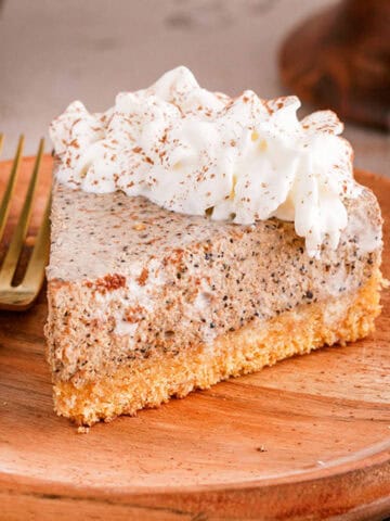 Tiramisu Cheesecake On a Plate With Whipped Cream and Fork