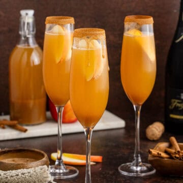 Apple Cider Mimosa in Champagne Flutes rimmed with Cinnamon Sugar