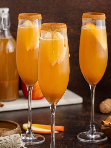 Apple Cider Mimosa in Champagne Flutes rimmed with Cinnamon Sugar