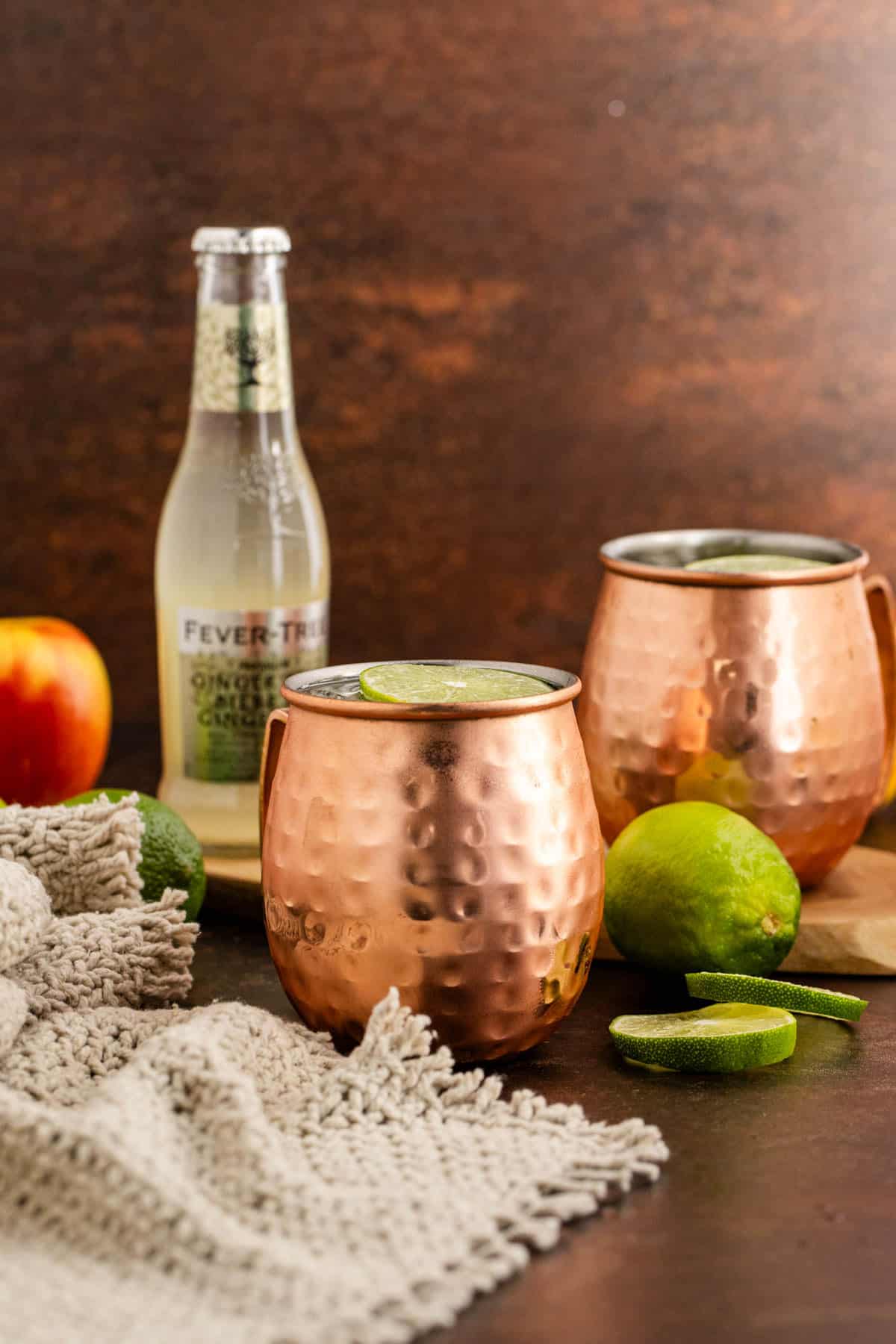 Apple Cider Moscow Mule in Glasses with Ginger Beer in Back