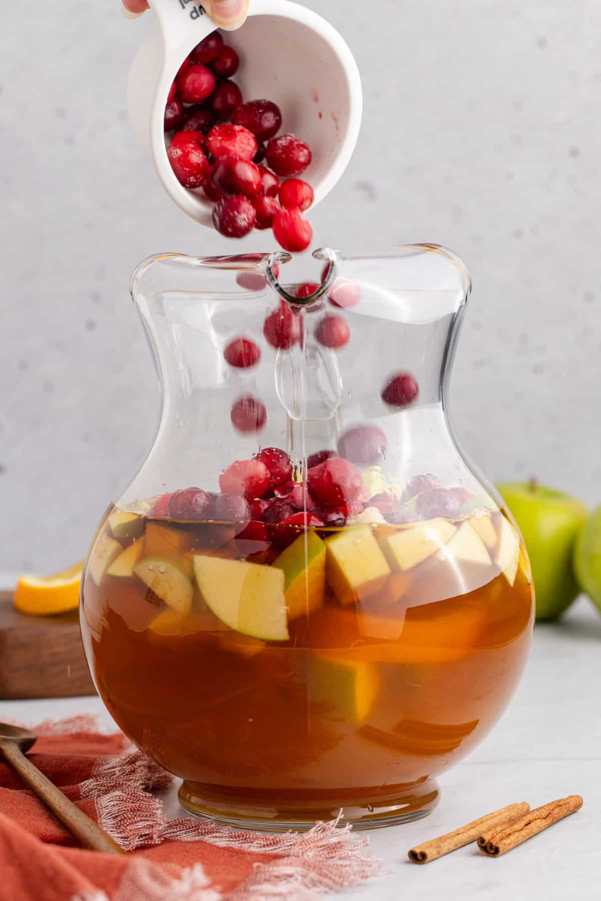 Apple Cider Sangria with White Wine Being Made in a Pitcher