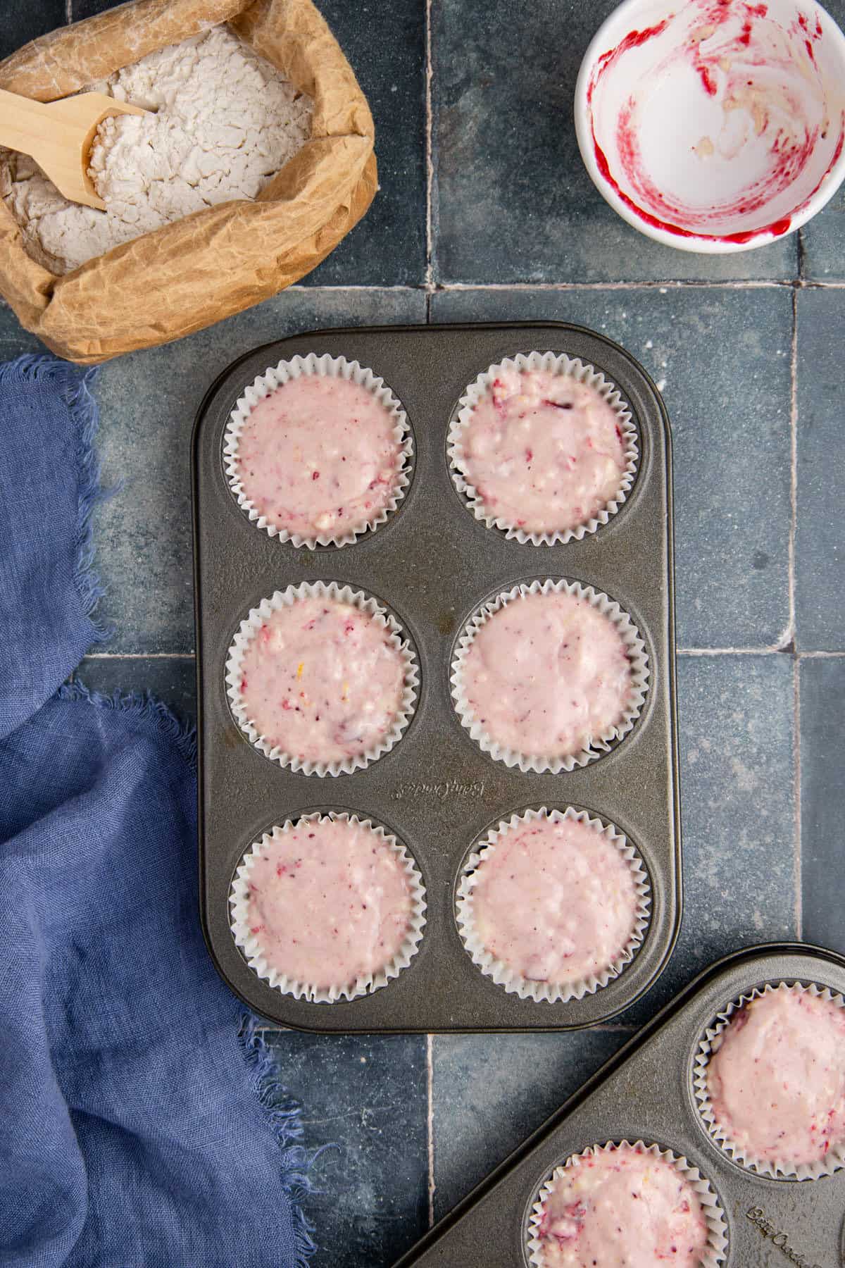 Cranberry Sauce Muffins Batter in a Muffin Tray To Be Baked