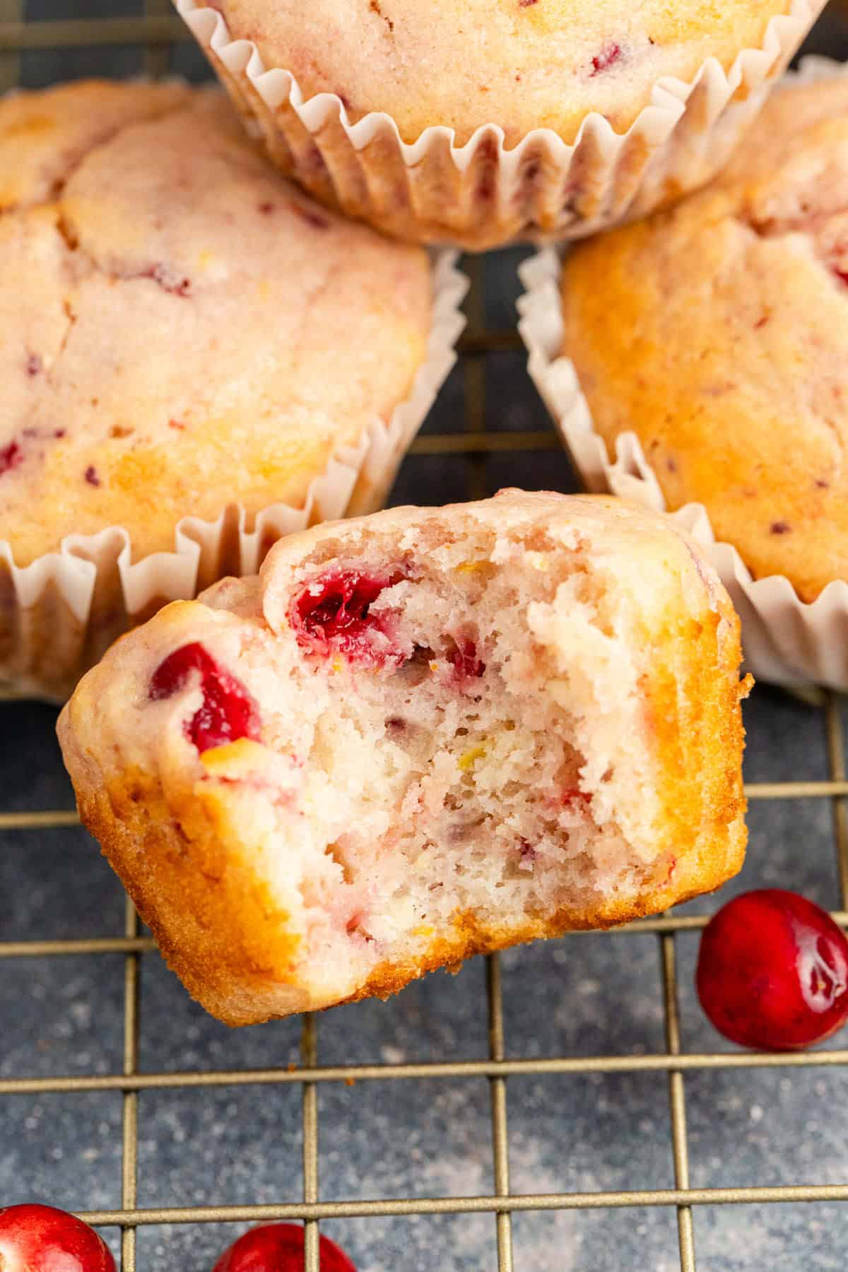 Cranberry Sauce Muffins on Cooling Rack with a Bite Taken