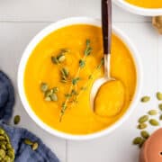 Roasted Butternut Squash and Garlic Soup with Spoon in a Bowl