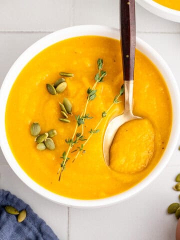 Roasted Butternut Squash and Garlic Soup with Spoon in a Bowl