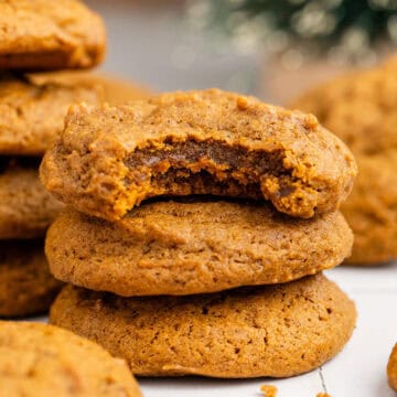 Spicy Chewy Ginger Molasses Cookies Stacked with a Bite Taken