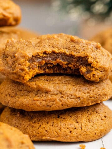 Spicy Chewy Ginger Molasses Cookies Stacked with a Bite Taken