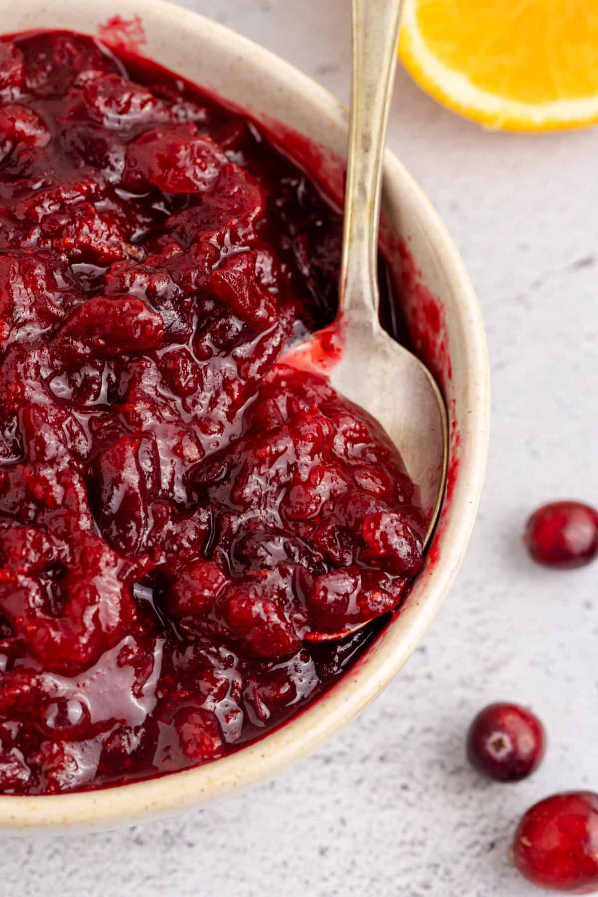 Whole Berry Cranberry Sauce in a Bowl with a Spoon