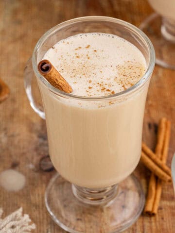 Baileys and Eggnog in a Cocktail glass with a Cinnamon