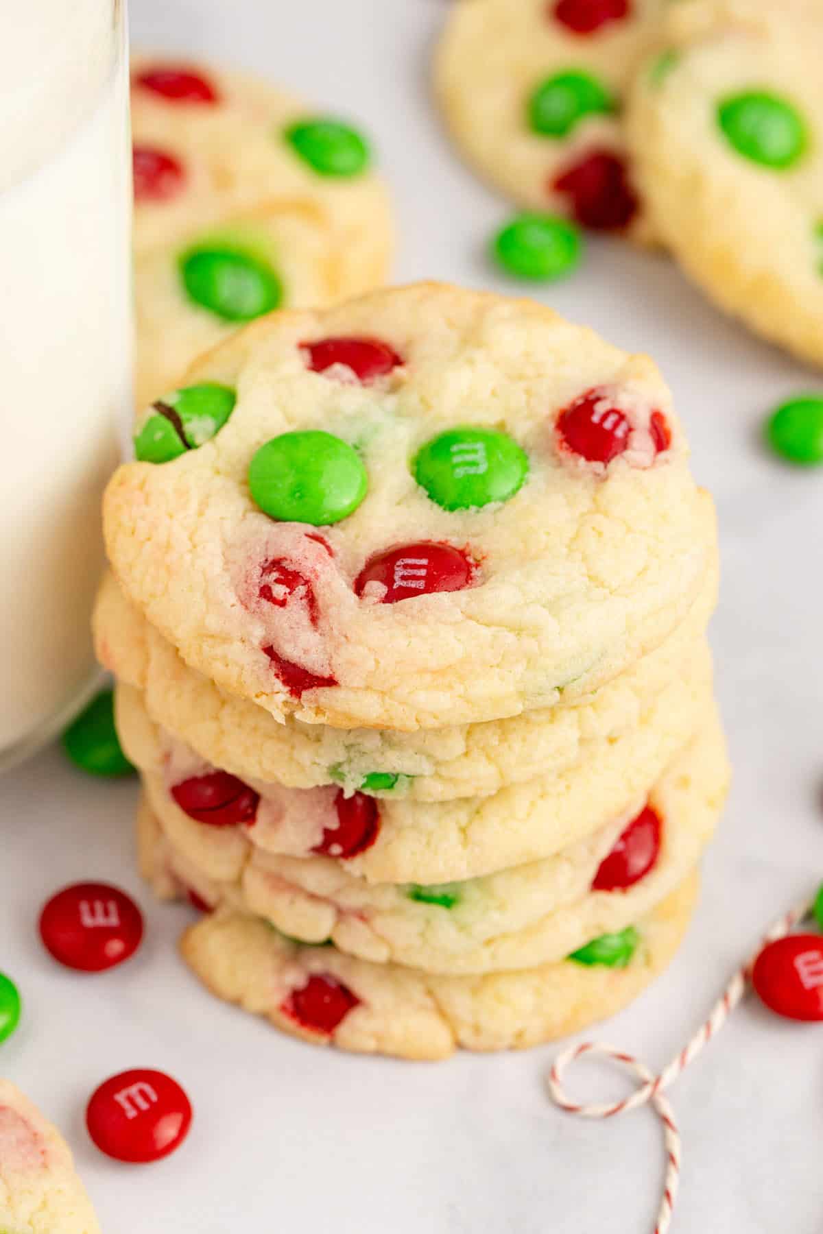 Cake Mix Christmas Cookies Stacked with M&Ms Beside Milk