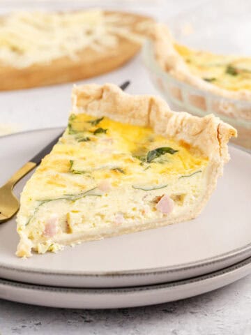 Spinach Ham Quiche Lorraine Slice on a Plate with Fork