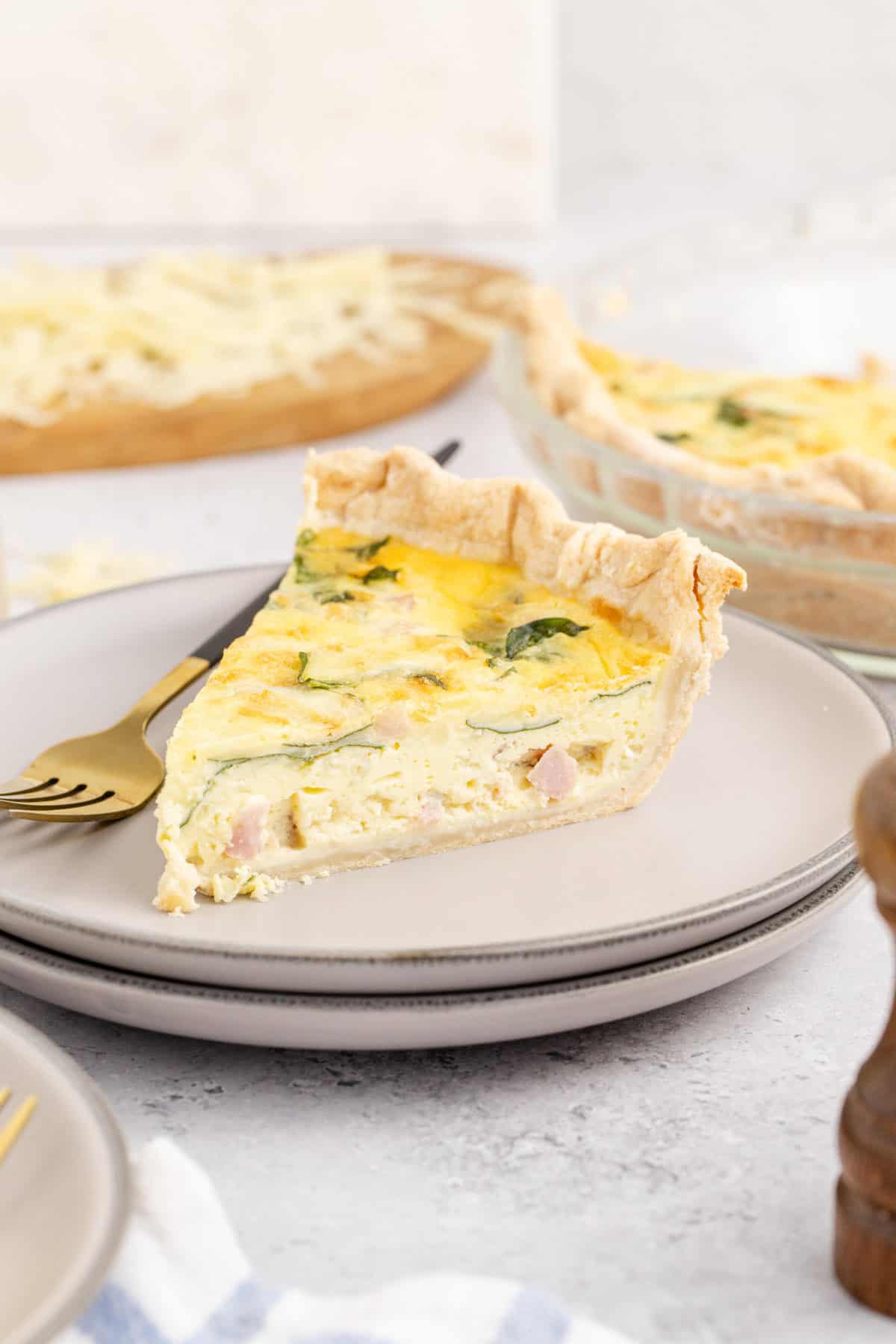 Spinach Ham Quiche Lorraine Slice on a Plate with Fork