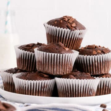 Double Chocolate Chunk Muffins Stacked on a Plate