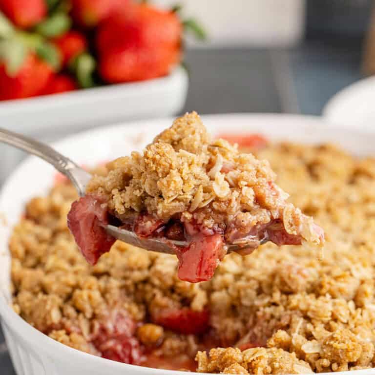 Strawberry Crisp Recipe Being Scooped Out of Dish