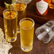 Fireball Shots on a counter with a shot glass beside