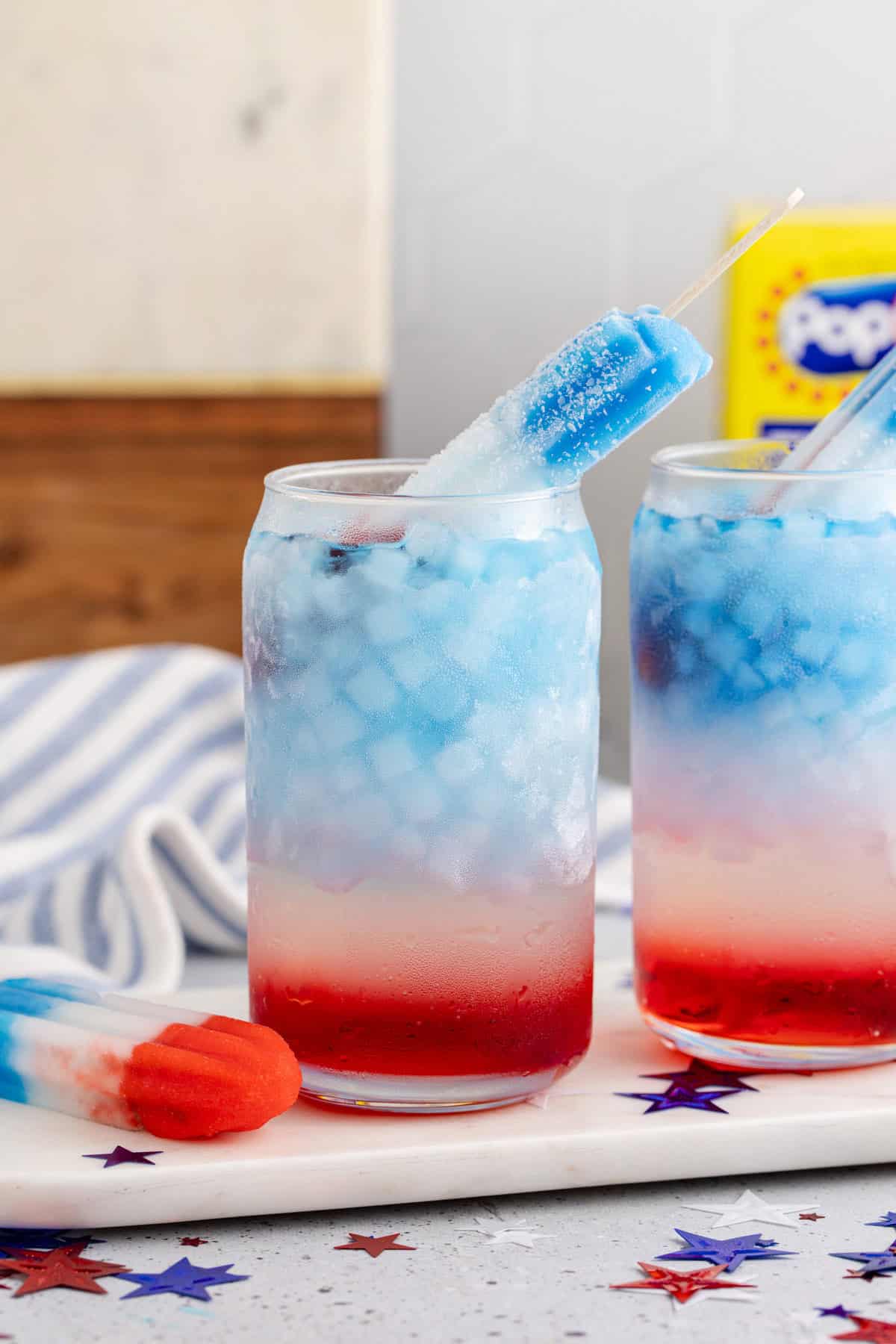 Bomb Pop Cocktail with a Popsicle beside and inside the glass