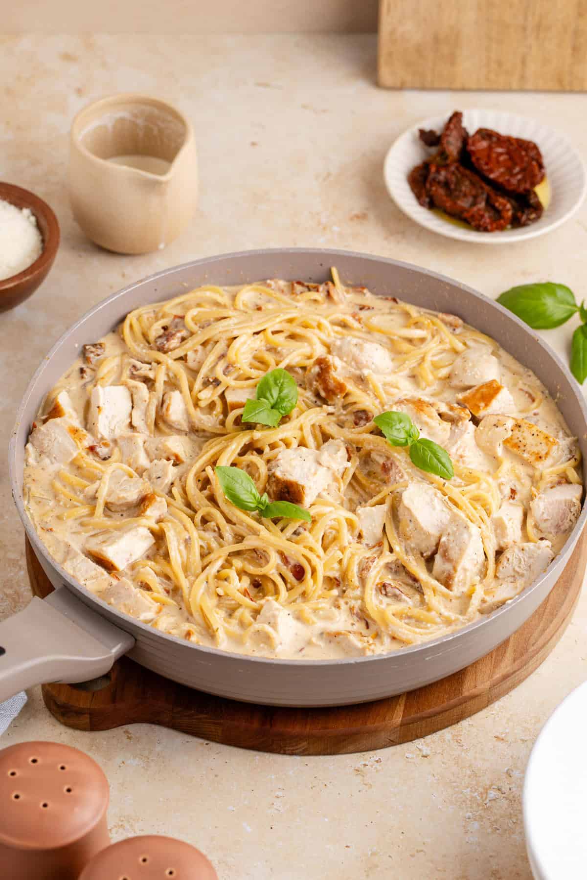 Creamy Sun Dried Tomato Chicken Pasta garnish with fresh basil