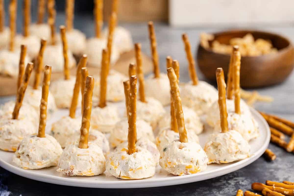 Mini Cheese Balls with pretzel sticks on a plate