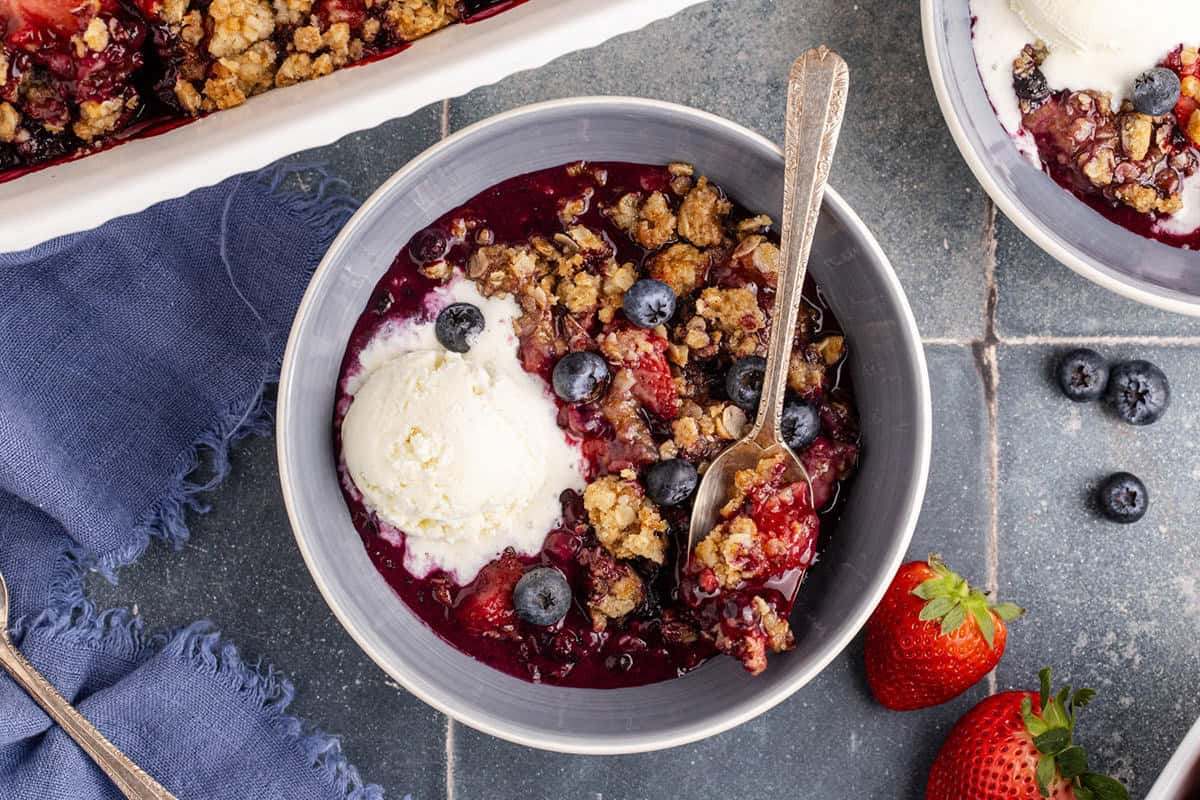 Mixed Berry Crisp with Frozen Berries in a bowl with ice cream