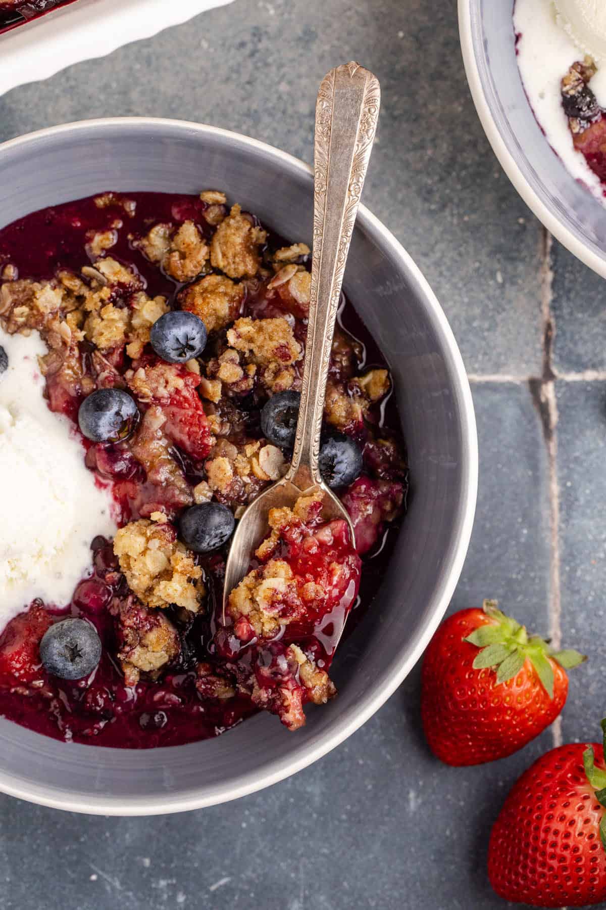Mixed Berry Crisp with Frozen Berries in a bowl with a spoon