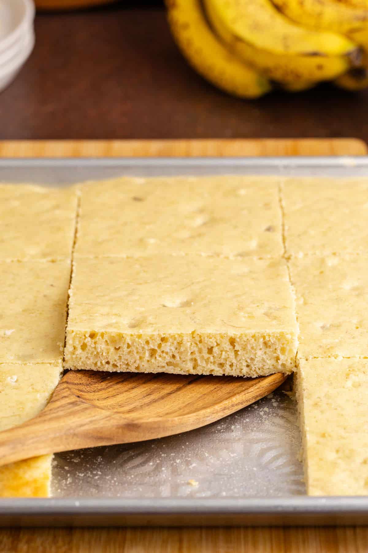 Sheet Pan Banana Pancakes baked being taken off the pan with a flipper
