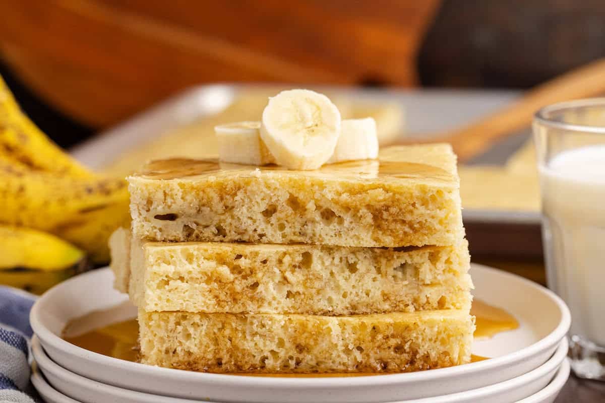 Sheet Pan Banana Pancakes Stacked on a plate with banana slices on top