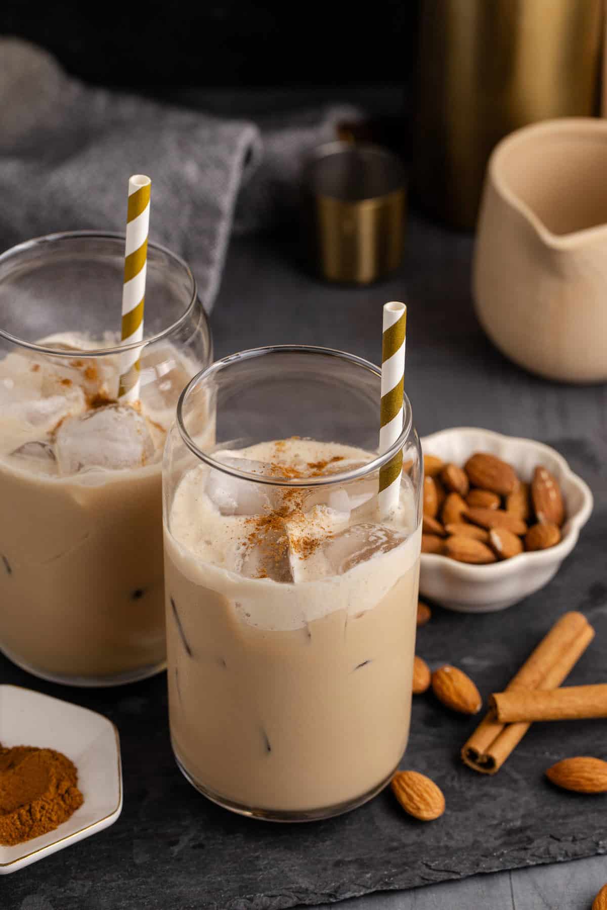 Toasted Almond Cocktails with a straw and a bowl of almonds
