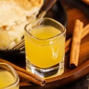 Apple Pie Shots on a Tray with Pie in the back