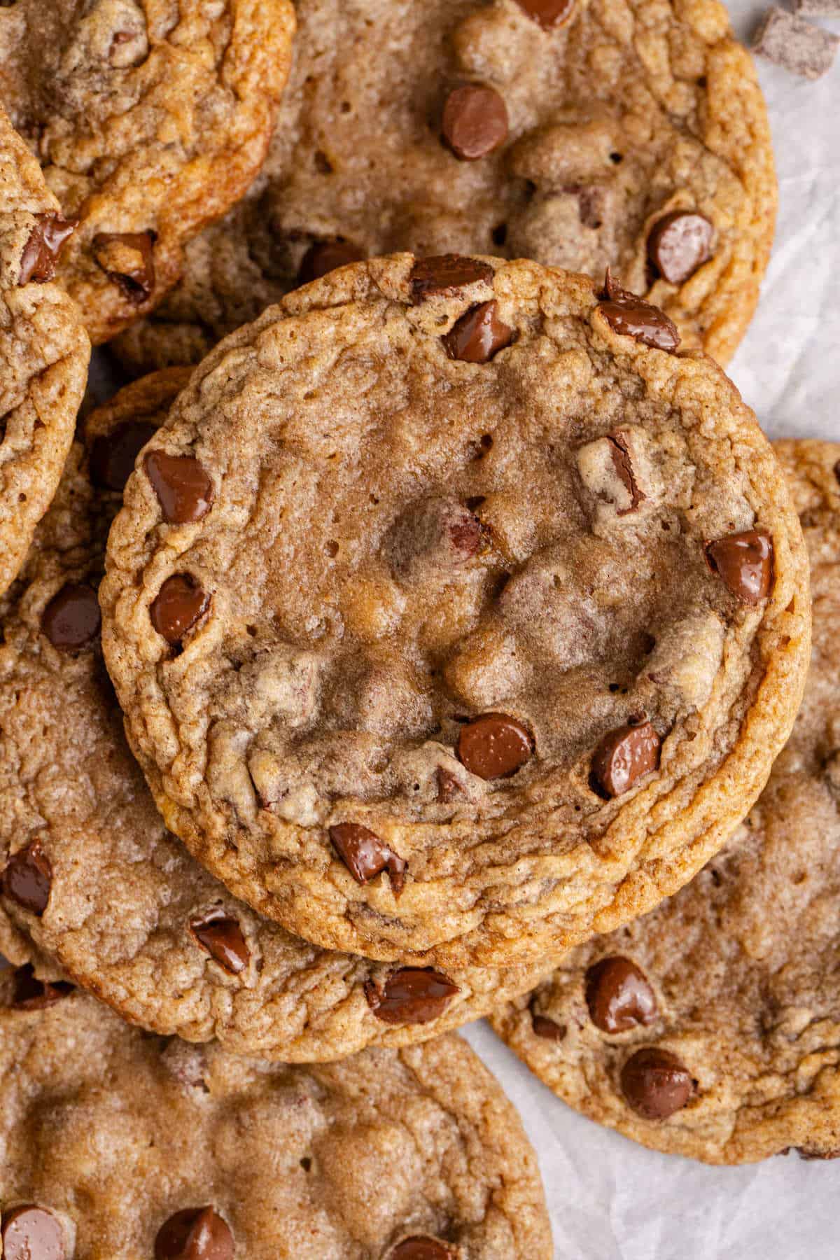 Banana Chocolate Chip Cookies stacked on parchment paper