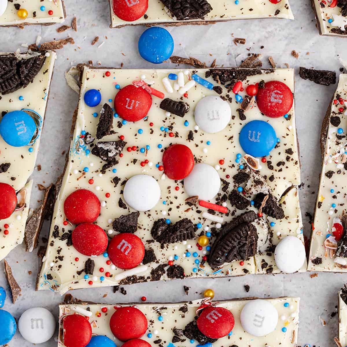 Red, White and Blue Bark Candy broken into pieces with M&Ms, Oreos and sprinkles