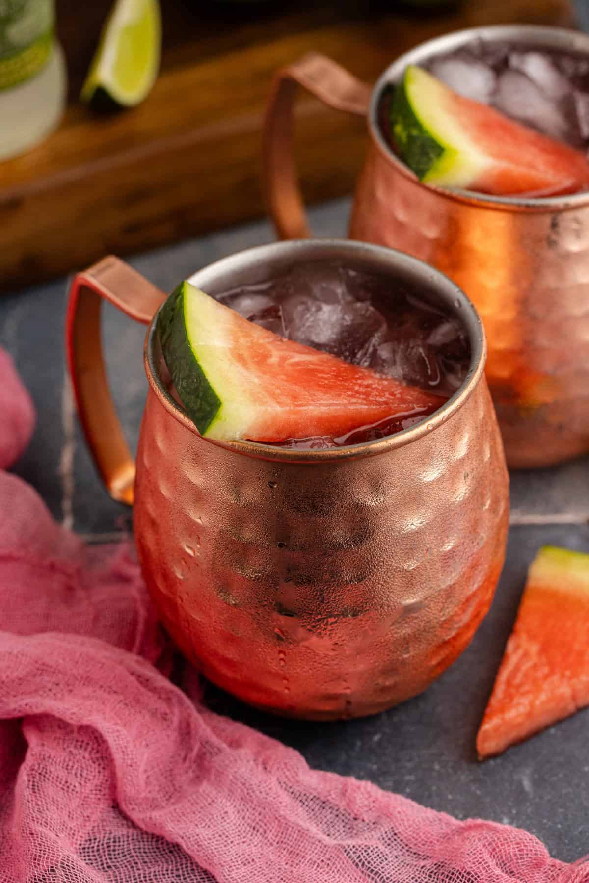 Watermelon Moscow Mule in Mule glasses with watermelon garnish from above close up