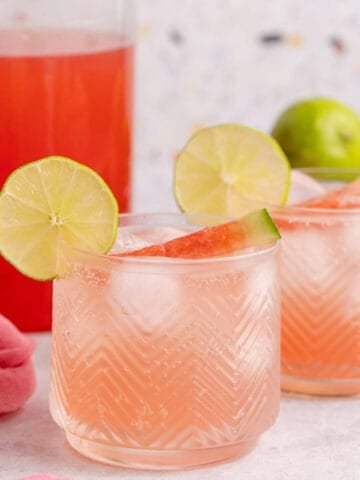 Watermelon Sangria Over Ice Garnished with Lime Slice and Watermelon Wedge