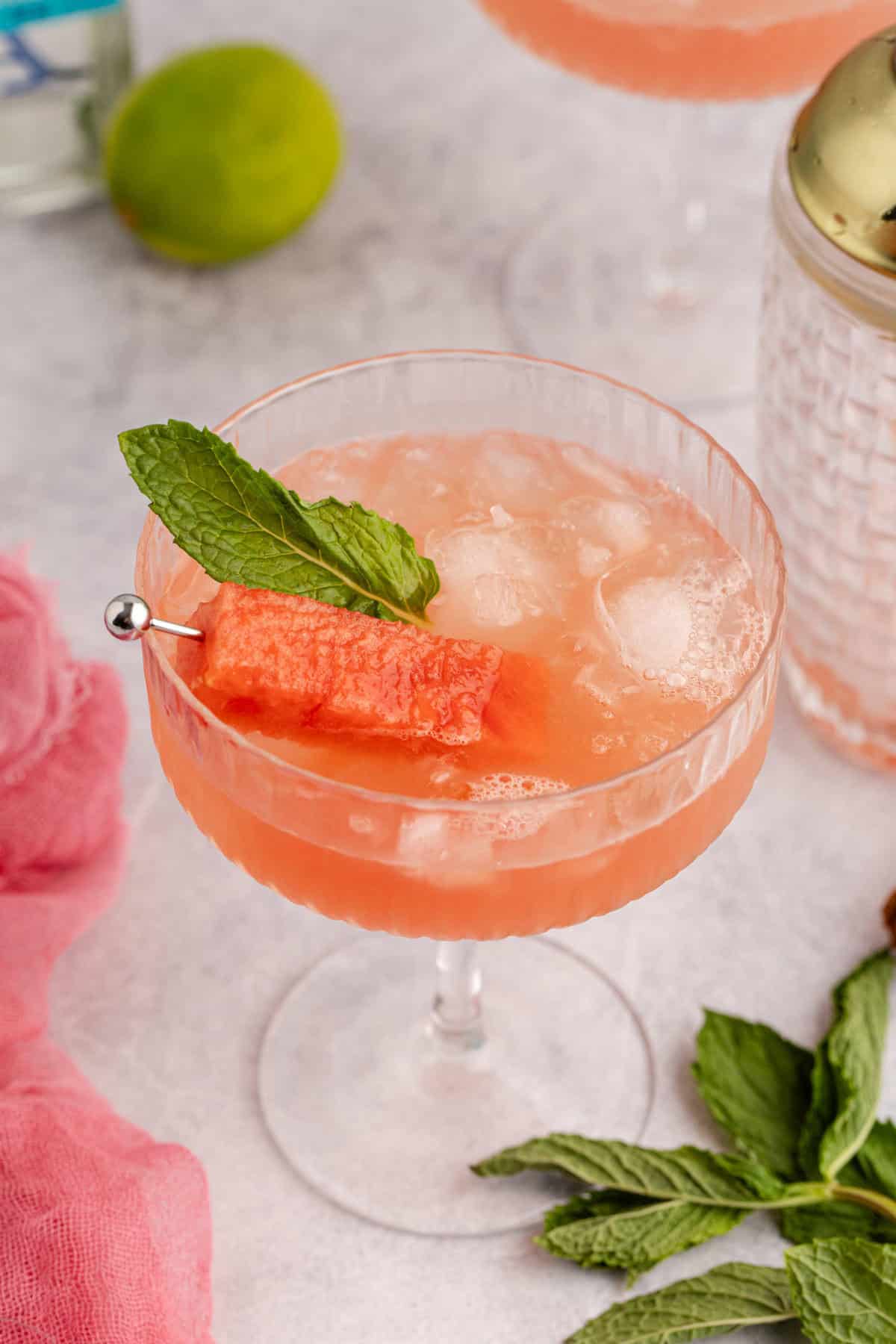 Watermelon Sour Served in Coupe with Watermelon Cube and Mint Leaf Garnish