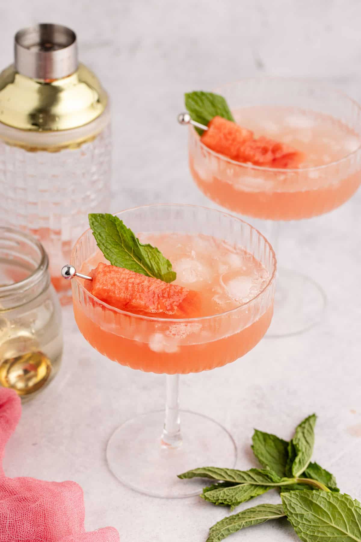 Watermelon Sour Served in Coupe with Watermelon Cube and Mint Leaf Garnish