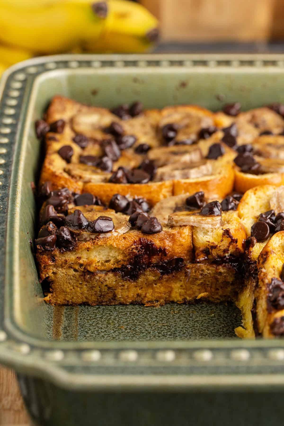 Banana French Toast Casserole in a dish showing a scoop taken